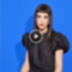 image of video with a person facing forward on a blue background.